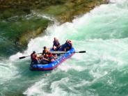 White water rafters paddling through rough water