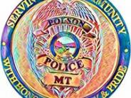 City of Polson police emblem/coin with a multi color police badge in the center 