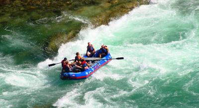 White water rafters paddling through rough water
