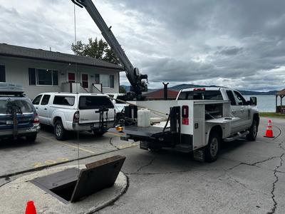 Truck lifting equipment out of a vault 